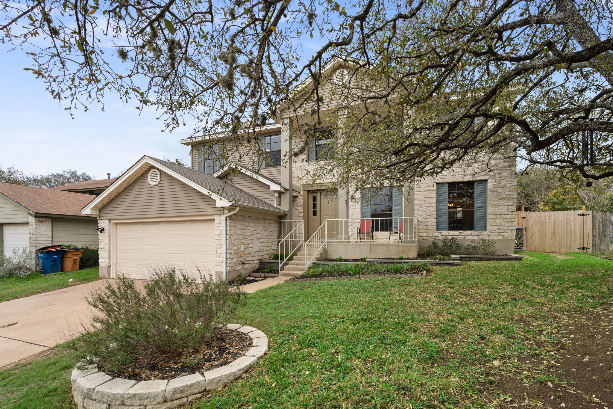 11942 Bittern Hollow Austin, TX 78758 - Photo 2 of 29 a front view of a house with a yard and trees