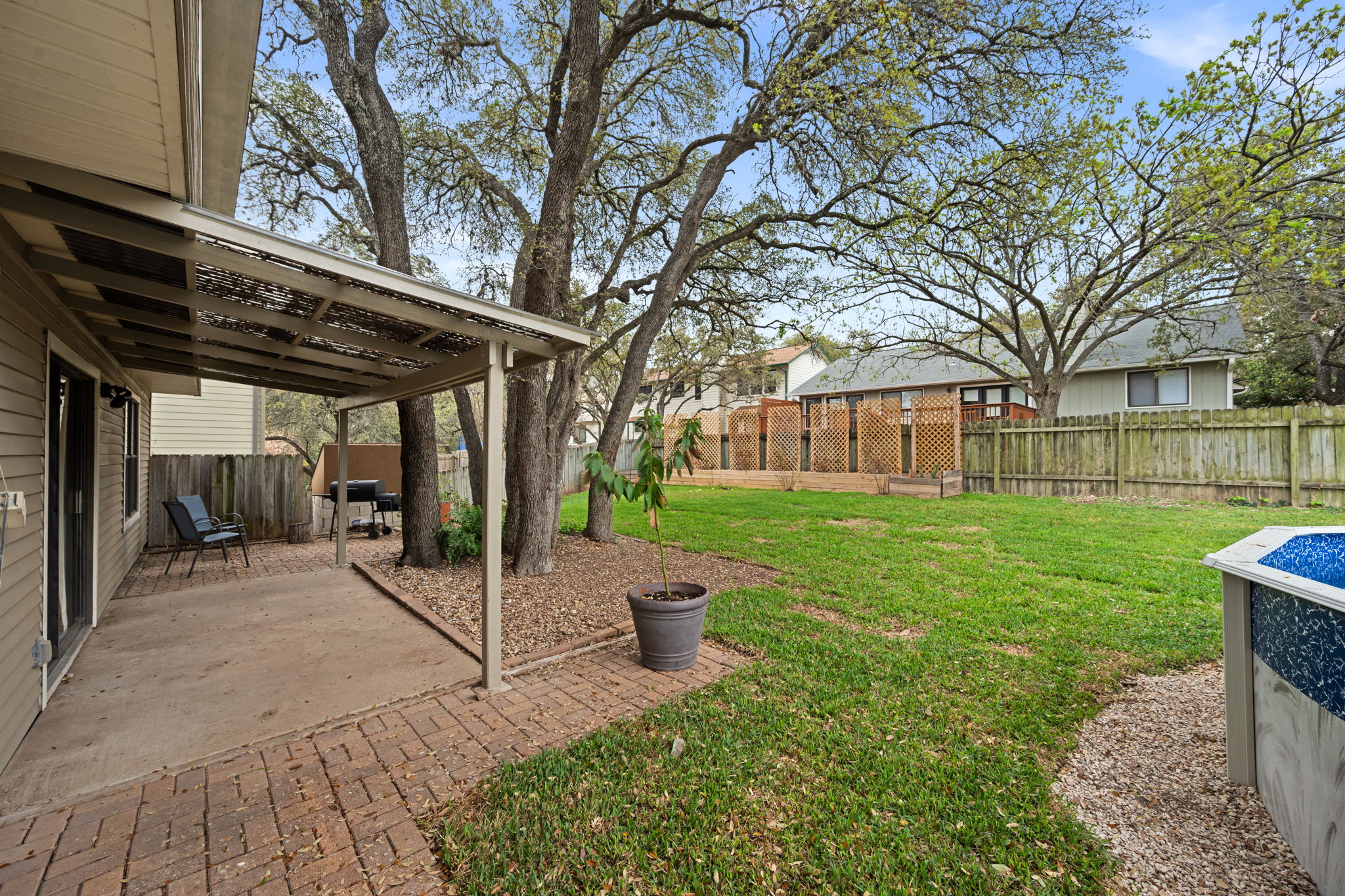11942 Bittern Hollow Austin, TX 78758 - Photo 23 of 29 a view of a patio with a table and chairs and a barbeque
