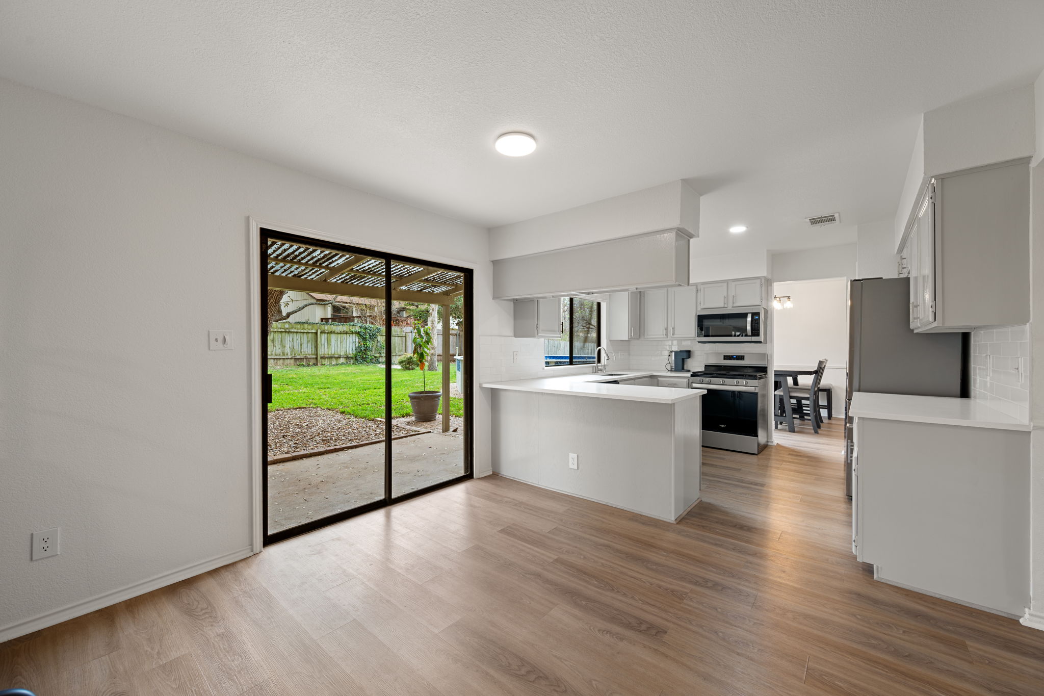 11942 Bittern Hollow Austin, TX 78758 - Photo 6 of 29 a view of kitchen with refrigerator and wooden floor