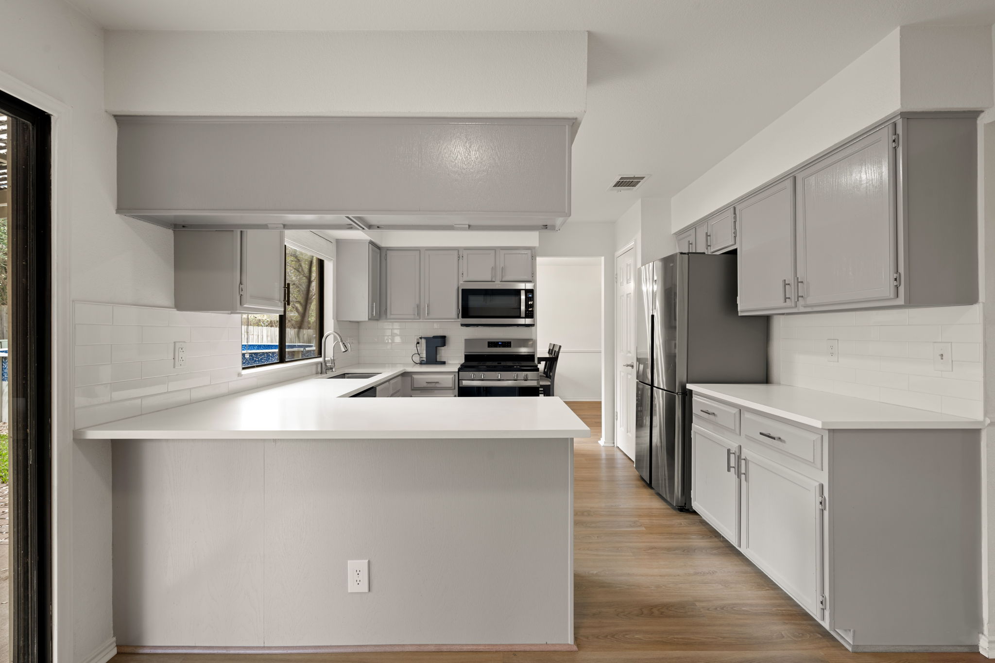 11942 Bittern Hollow Austin, TX 78758 - Photo 8 of 29 a kitchen with stainless steel appliances a refrigerator stove microwave and sink