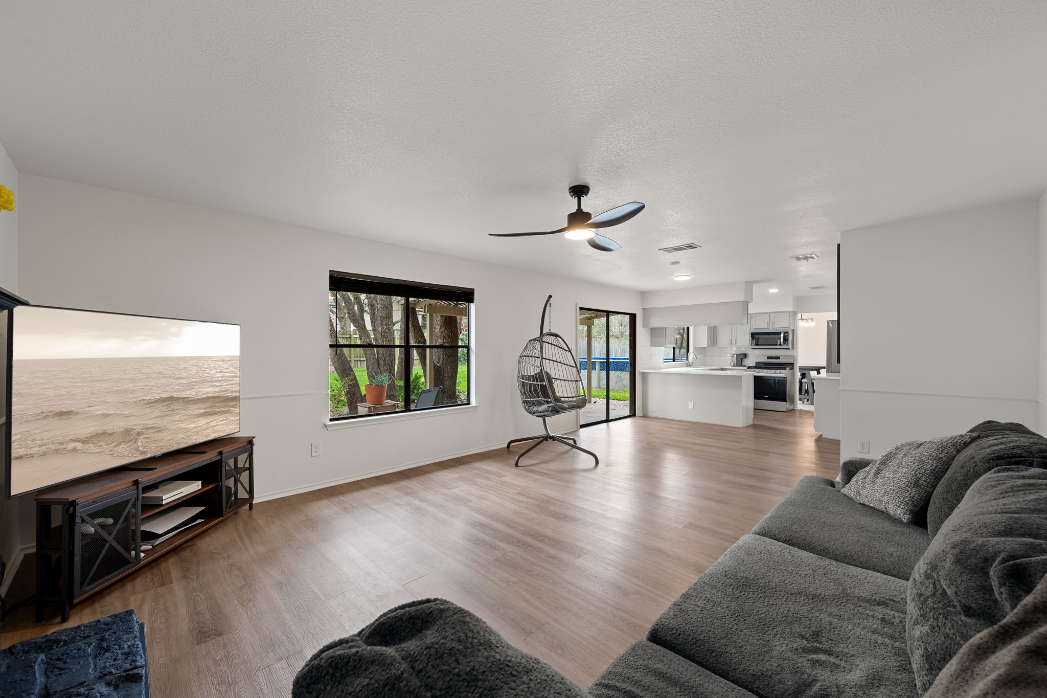 11942 Bittern Hollow Austin, TX 78758 - Photo 9 of 29 a living room with furniture and a flat screen tv