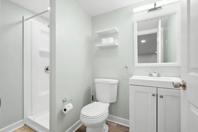 a bathroom with a toilet sink and mirror