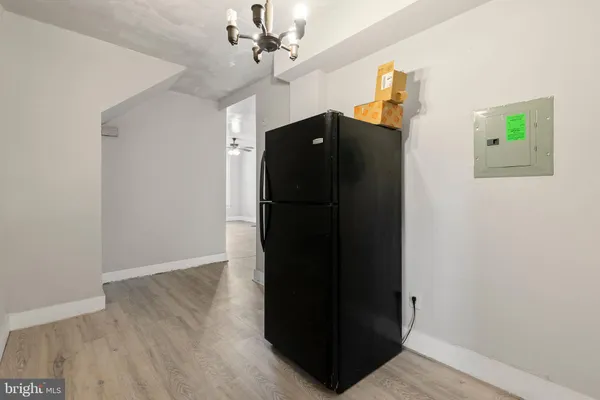 a view of a hallway with wooden floor and closet area