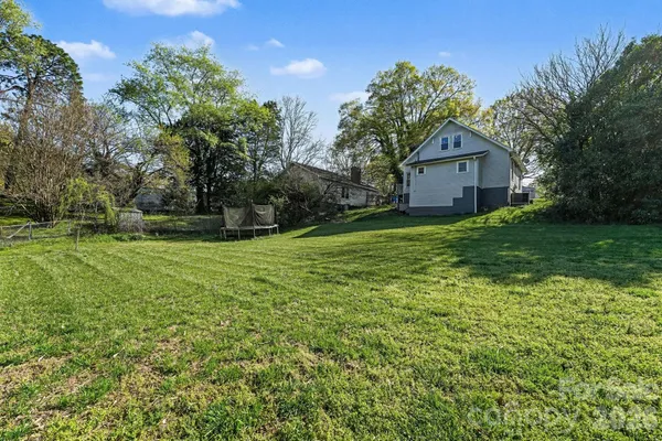 a view of a house with yard and a tree