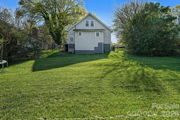 a view of backyard of house with green space