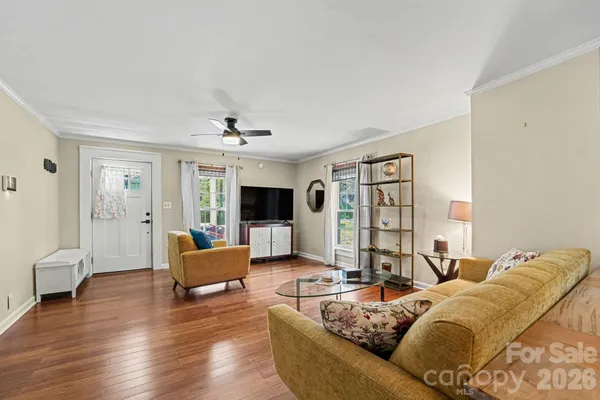 a living room with furniture and a flat screen tv