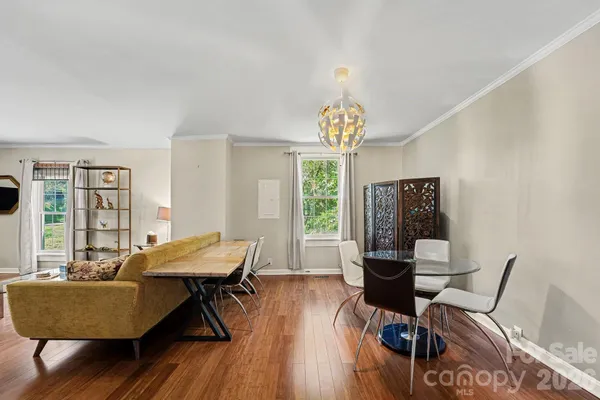 a view of a dining room with furniture window and wooden floor