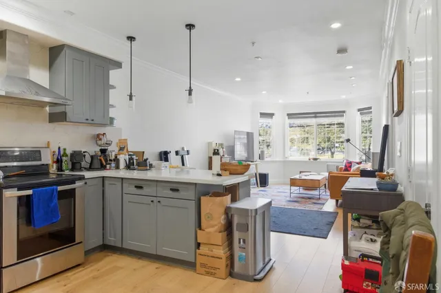 a kitchen with stainless steel appliances granite countertop a sink a stove and a refrigerator