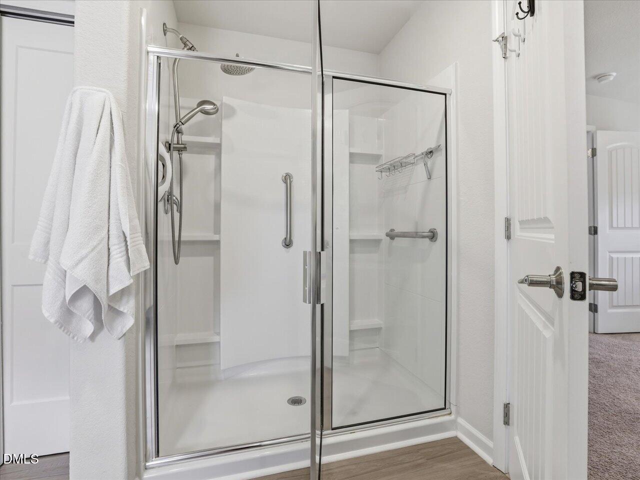 90 Barnsley Road Angier, NC 27501 - Photo 23 of 40 a bathroom with a glass shower door