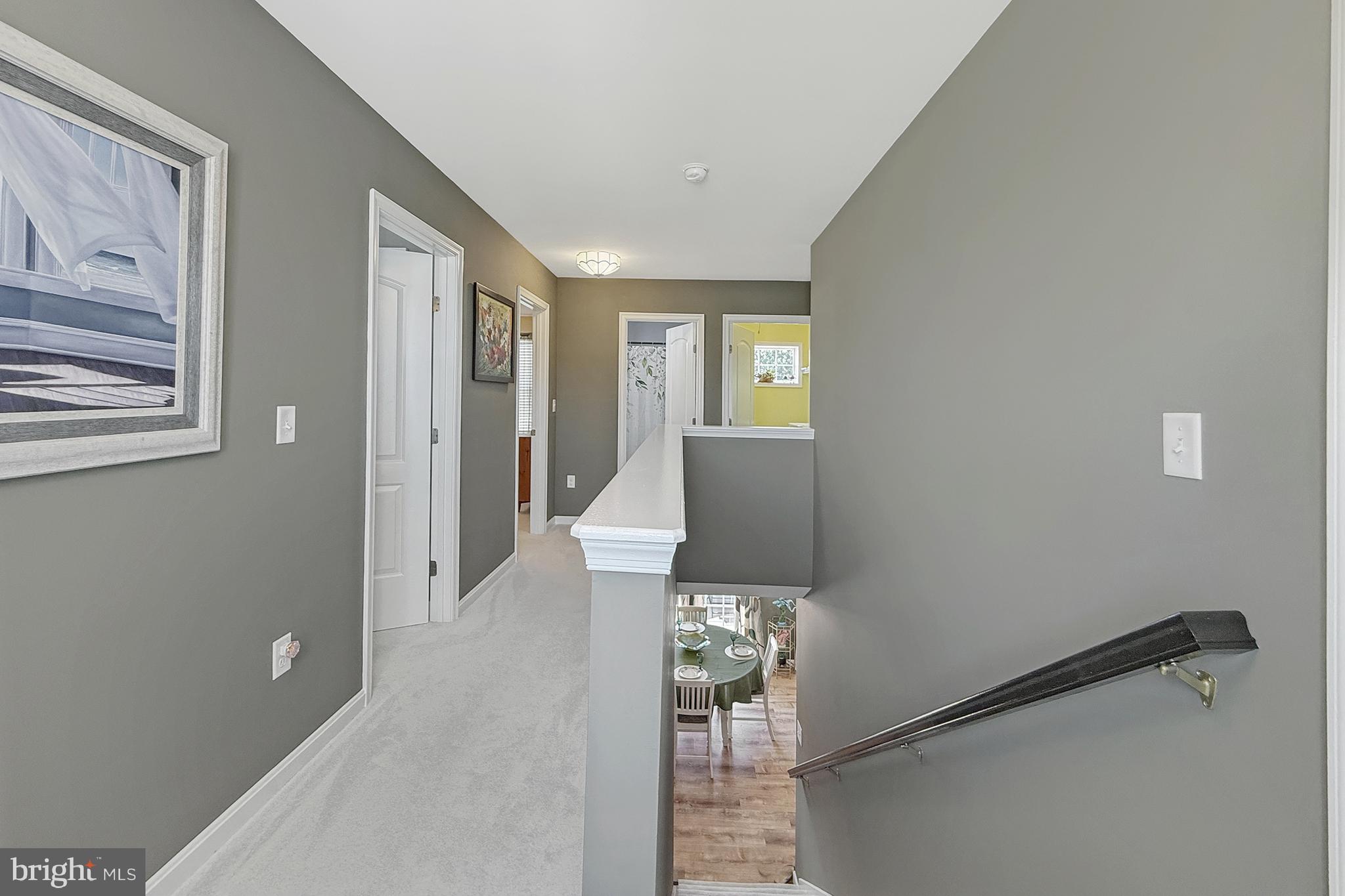 87 Trapper Lane Magnolia, DE 19962 - Photo 20 of 39 a view of a hallway with wooden floor and a livingroom