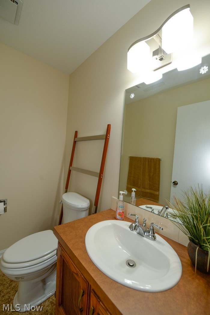 347 Silver Ridge Drive Akron, OH 44321 - Photo 22 of 31 Completely updated half bathroom with wood cabinet, built in sink with new silver hardware and lighting.