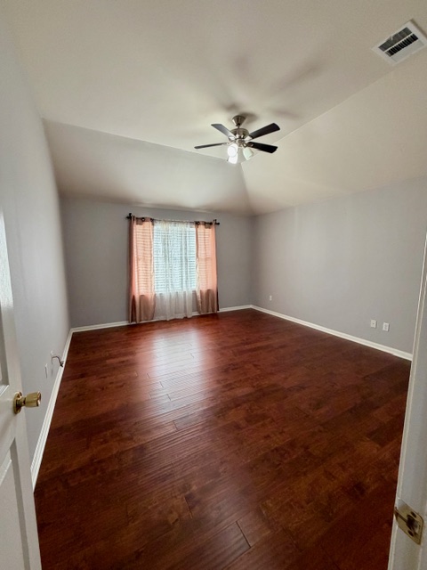 708 Ranier Lane Round Rock, TX 78665 - Photo 12 of 20 Spare room with lofted ceiling, dark wood finished floors, and ceiling fan