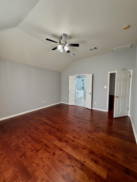 708 Ranier Lane Round Rock, TX 78665 - Photo 13 of 20 Unfurnished living room with vaulted ceiling and dark wood finished floors