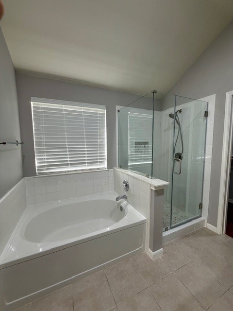 708 Ranier Lane Round Rock, TX 78665 - Photo 15 of 20 Full bath with a garden tub, a shower stall, light tile patterned floors, and vaulted ceiling