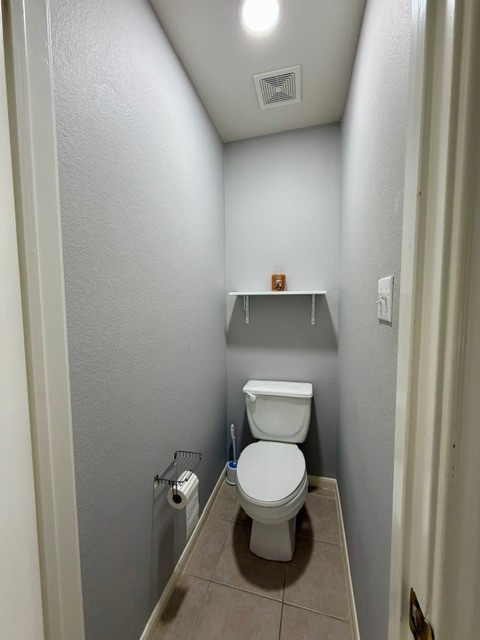 708 Ranier Lane Round Rock, TX 78665 - Photo 16 of 20 Bathroom featuring light tile patterned flooring and a textured wall