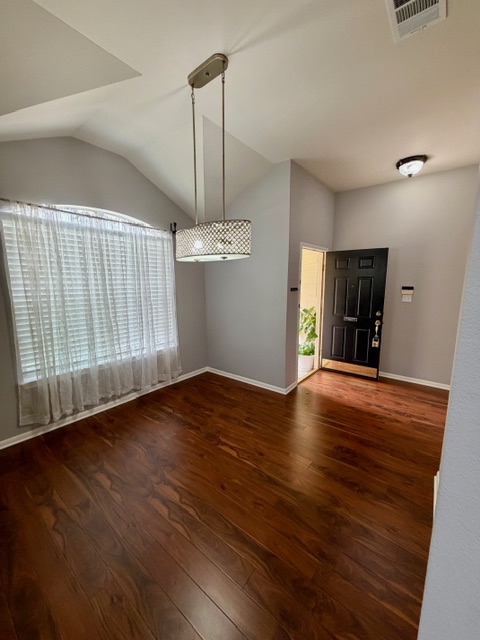 708 Ranier Lane Round Rock, TX 78665 - Photo 7 of 20 Entryway with vaulted ceiling and dark wood-type flooring
