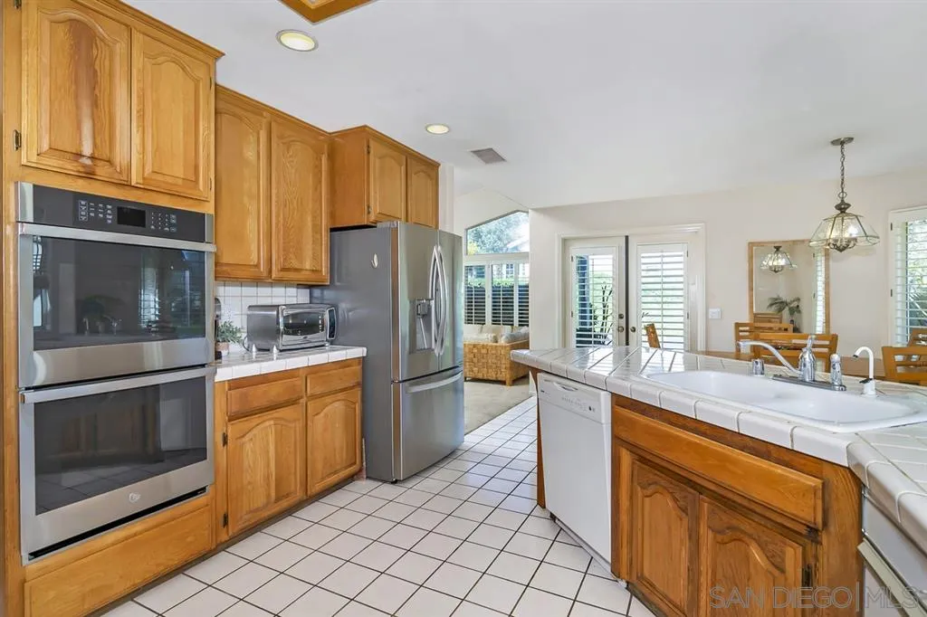 1631 Dewitt Estates Road Alpine, CA 91901 - Photo 11 of 25 a kitchen with stainless steel appliances granite countertop a stove a sink and a refrigerator