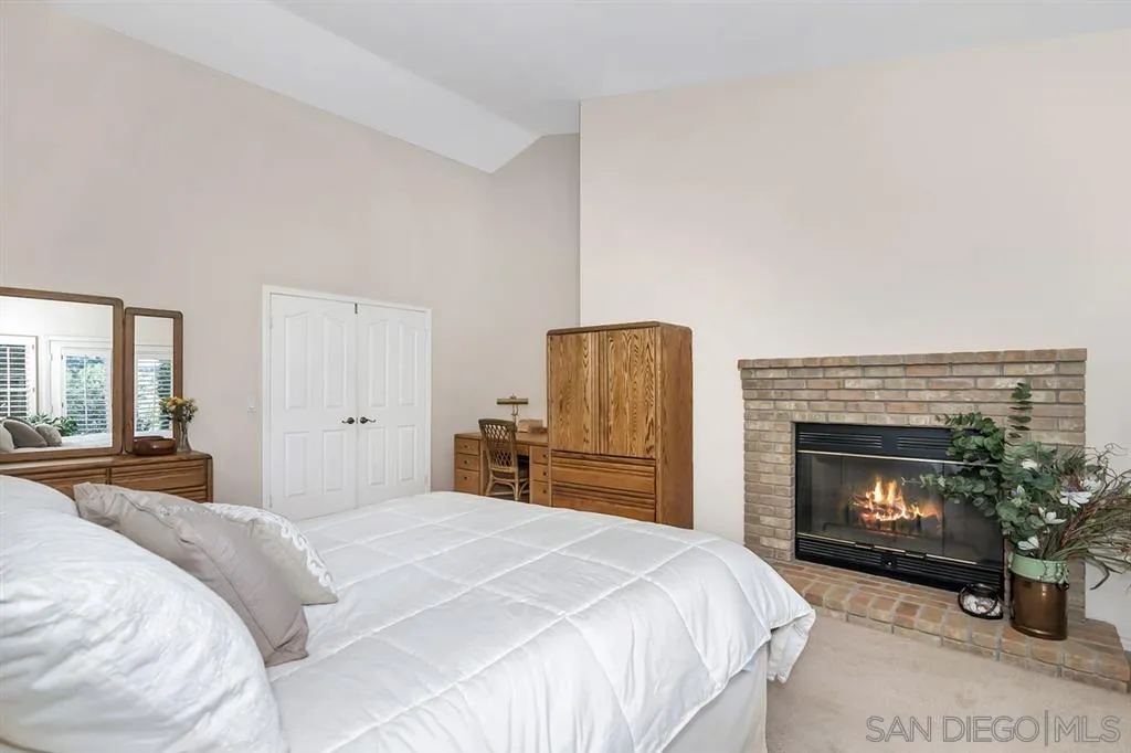 1631 Dewitt Estates Road Alpine, CA 91901 - Photo 20 of 25 a bedroom with a bed and a fireplace