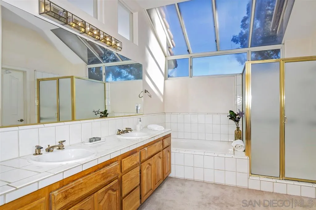 1631 Dewitt Estates Road Alpine, CA 91901 - Photo 22 of 25 a spacious bathroom with a double vanity sink a mirror and shower