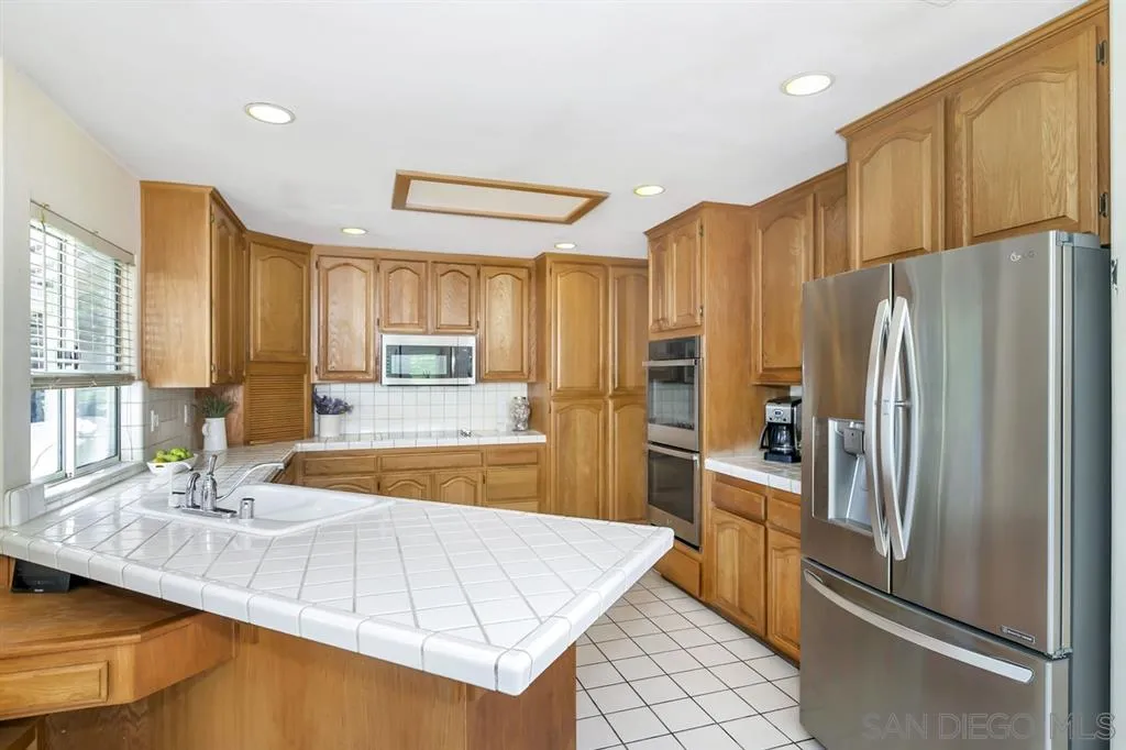 1631 Dewitt Estates Road Alpine, CA 91901 - Photo 9 of 25 a kitchen with stainless steel appliances a refrigerator sink and stove