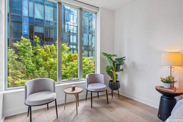 a utility room with dryer washer and a view of a bathroom
