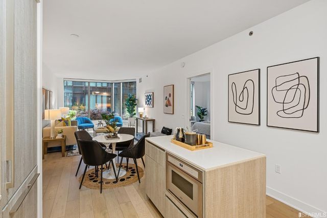 a kitchen with stainless steel appliances a stove a microwave and sink