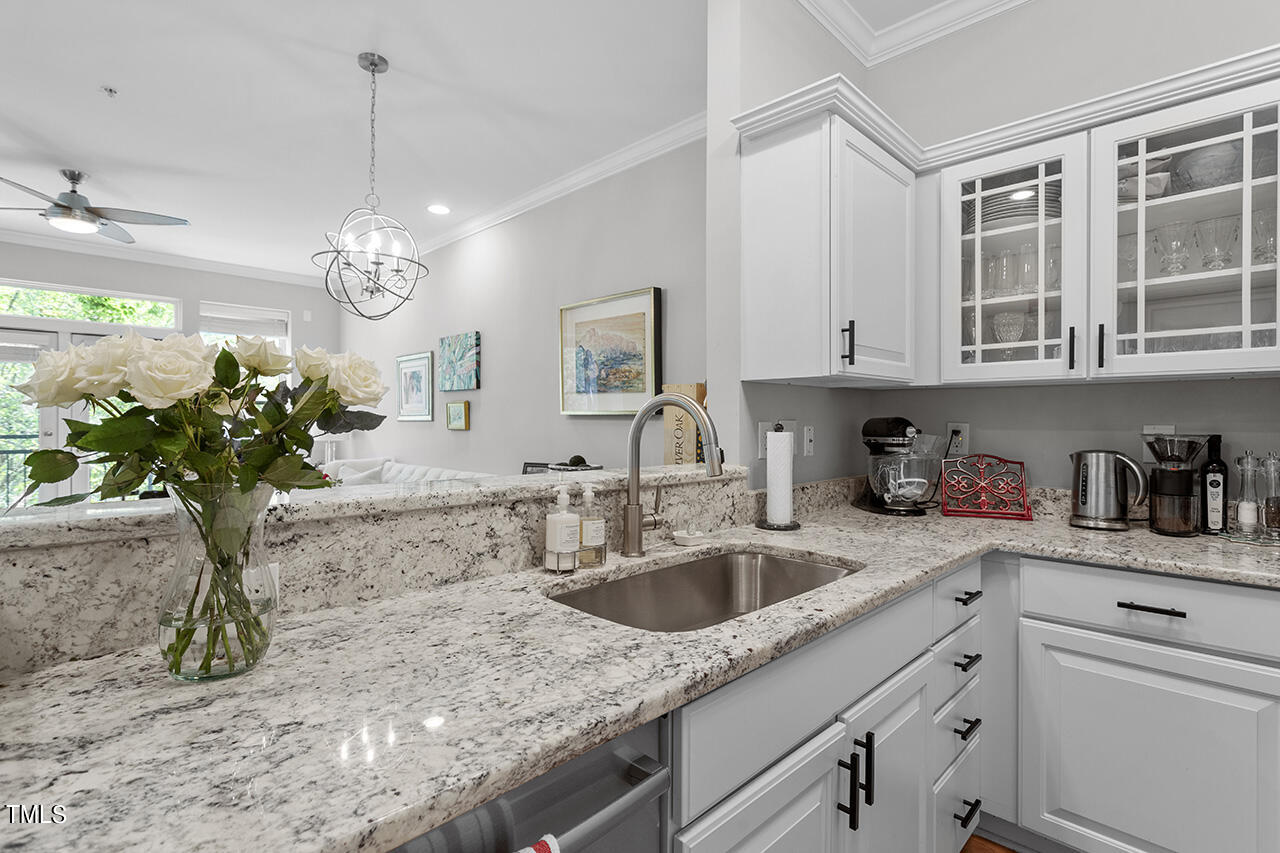 200 South Dawson Street, Unit 203 Raleigh, NC 27601 - Photo 19 of 35 Spacious kitchen features stainless steel appliances, granite countertops & storage opening to the dining & living room spaces.