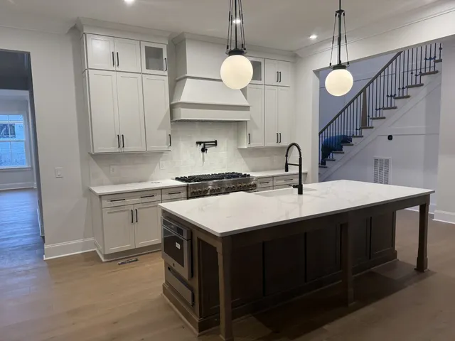 a view of a hallway with wooden floor and staircase