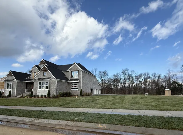 a kitchen with a sink dishwasher and a stove with wooden floor