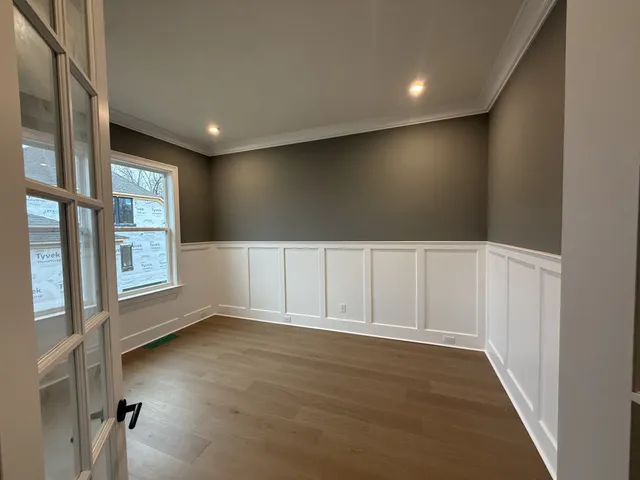 a kitchen with a stove and a wooden floors