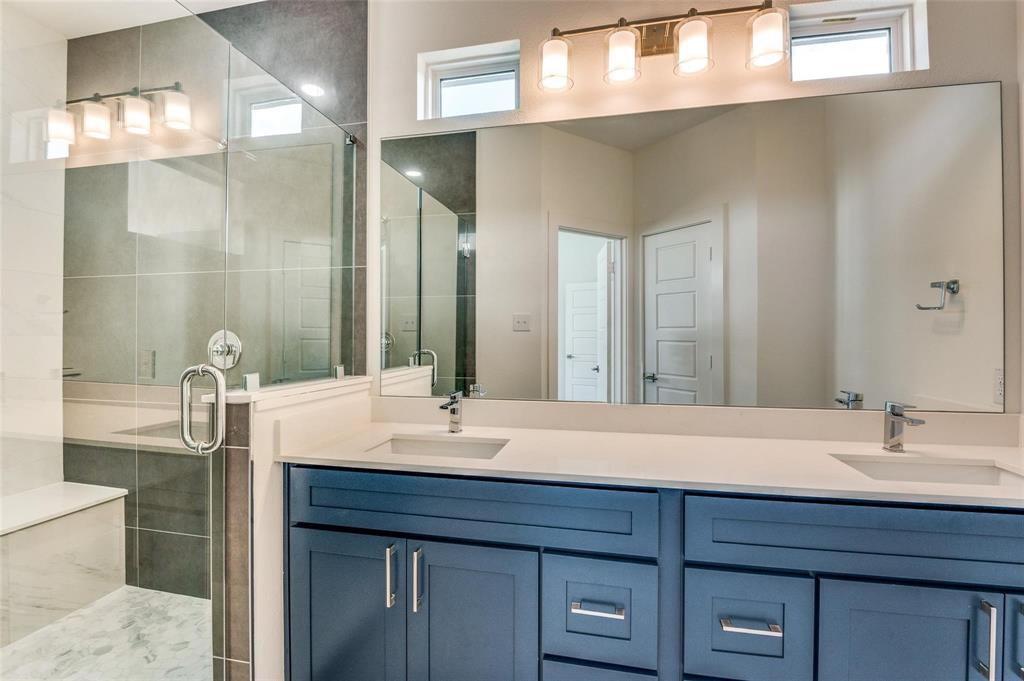 7307 Rubio Place Dallas, TX 75235 - Photo 12 of 17 a bathroom with a sink and a mirror