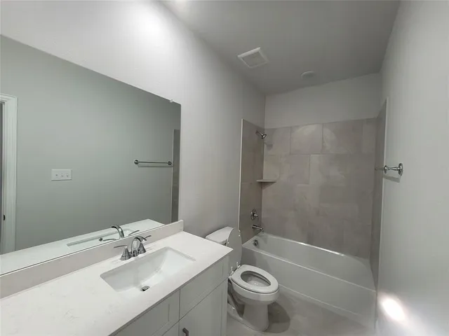 a bathroom with a sink mirror and toilet