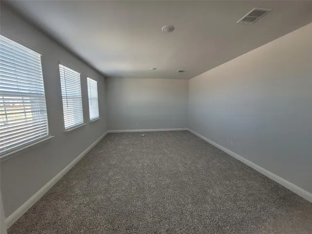 an empty room with a windows
