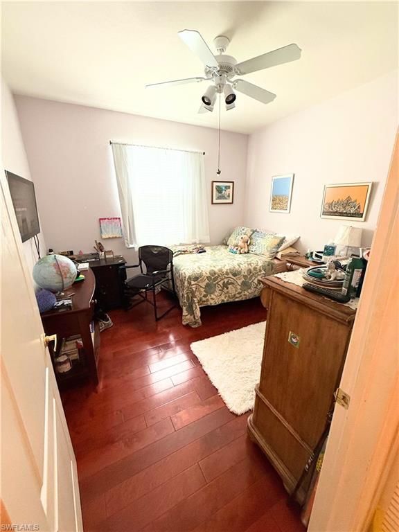 8490 Kingbird Loop, Unit 930 Estero, FL 33967 - Photo 4 of 12 Bedroom featuring dark wood finished floors and a ceiling fan