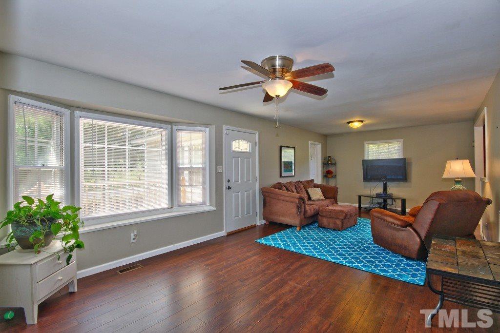 6317 Forestville Road Raleigh, NC 27604 - Photo 4 of 22 Large living area and dining room includes stunning hard wood floors and ceiling fan! New windows in 2014.