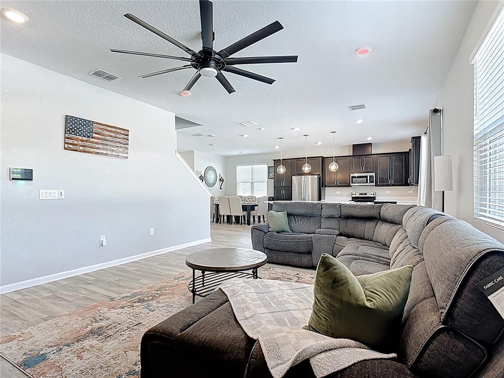 620 Grasshopper Ct Street St. Cloud, FL 34772 - Photo 11 of 29 a living room with furniture and a wooden floor