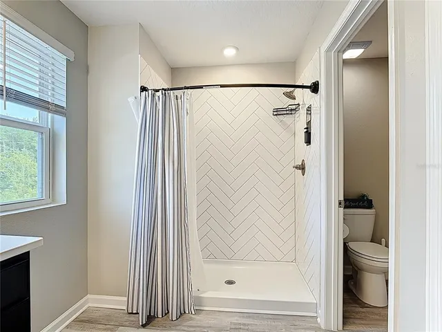 a bathroom with a glass shower door