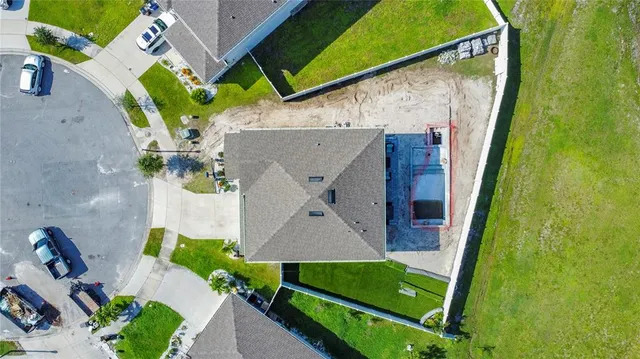 an aerial view of a house with swimming pool