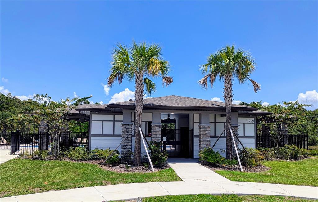 620 Grasshopper Ct Street St. Cloud, FL 34772 - Photo 28 of 29 a front view of a house with garden and palm trees