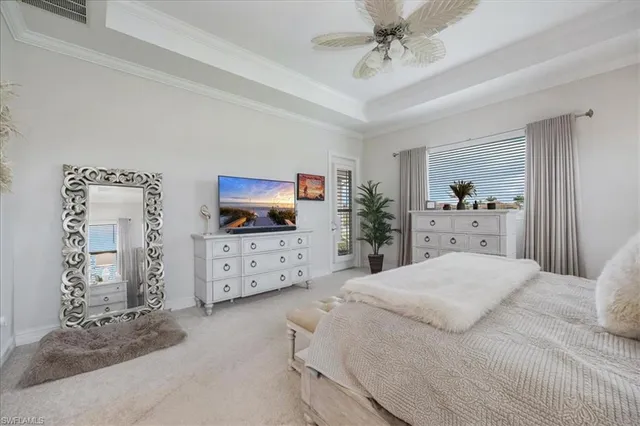 a bedroom with a bed and a flat tv screen on dresser