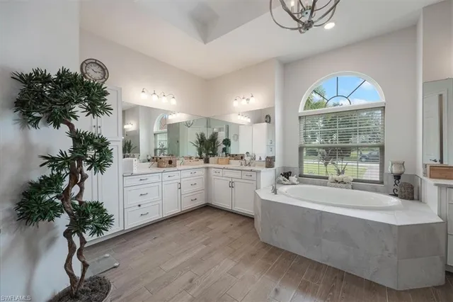 a large white room with mirror and a window