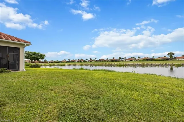 a view of a lake with houses in the back