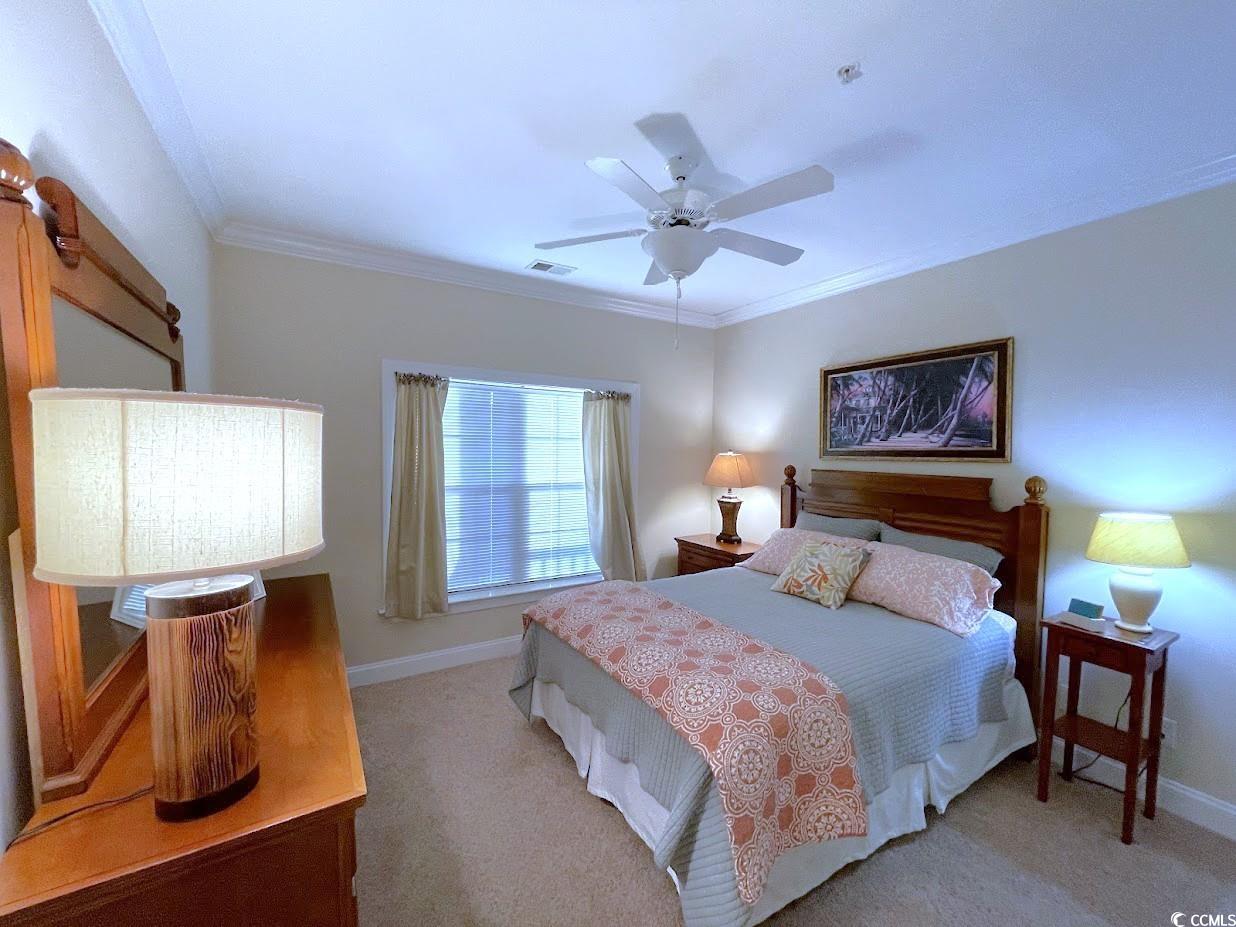 1008 Ray Costin Way, Unit 310 Murrells Inlet, SC 29576 - Photo 8 of 40 Carpeted bedroom with ceiling fan and crown moldin