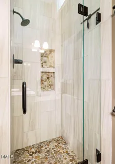 a bathroom with a shower and a window