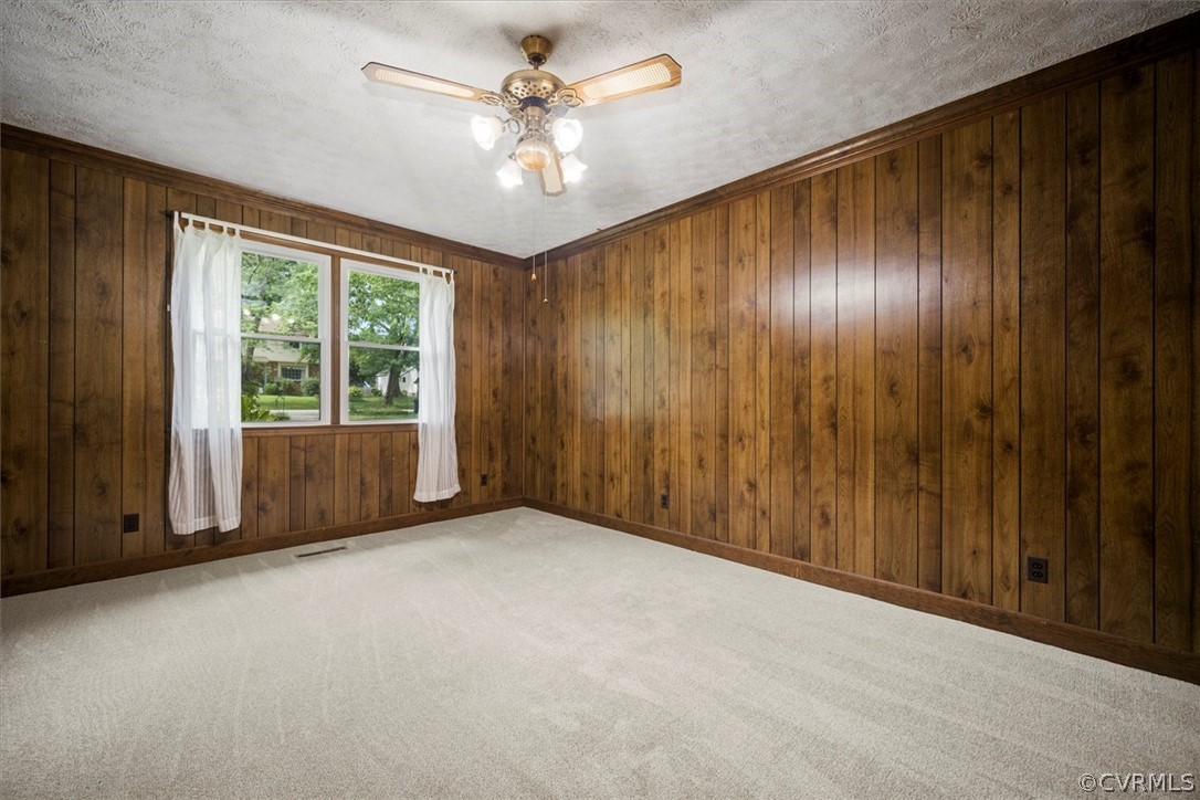 4005 Hidden Valley Road Chester, VA 23831 - Photo 17 of 43 an empty room with windows chandelier fan