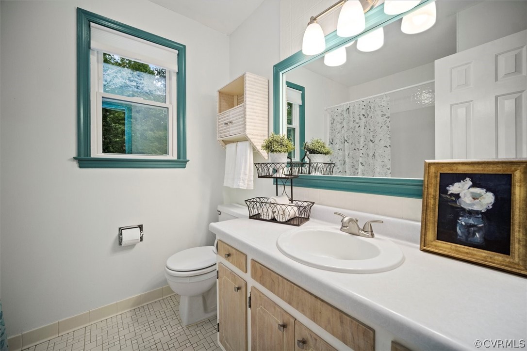 4005 Hidden Valley Road Chester, VA 23831 - Photo 30 of 43 a bathroom with a sink a toilet and a mirror