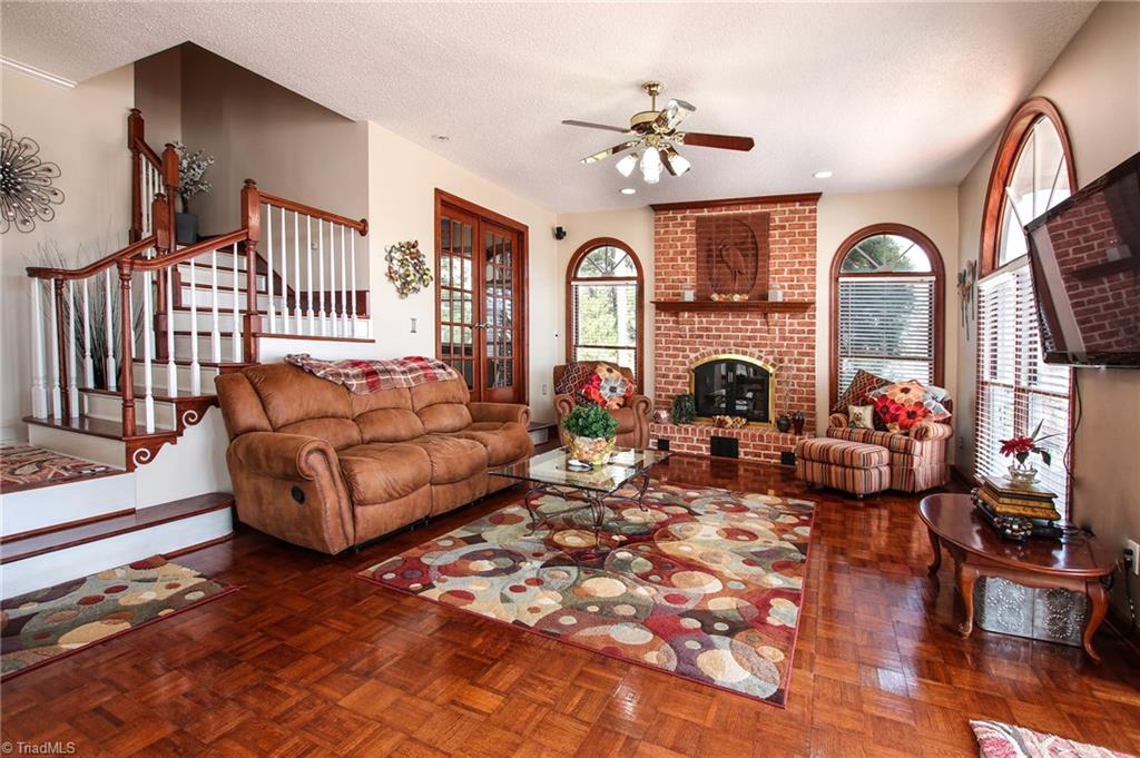516 Shoreline Road New London, NC 28127 - Photo 15 of 26 Living room leads out to brick patio overlooking lake