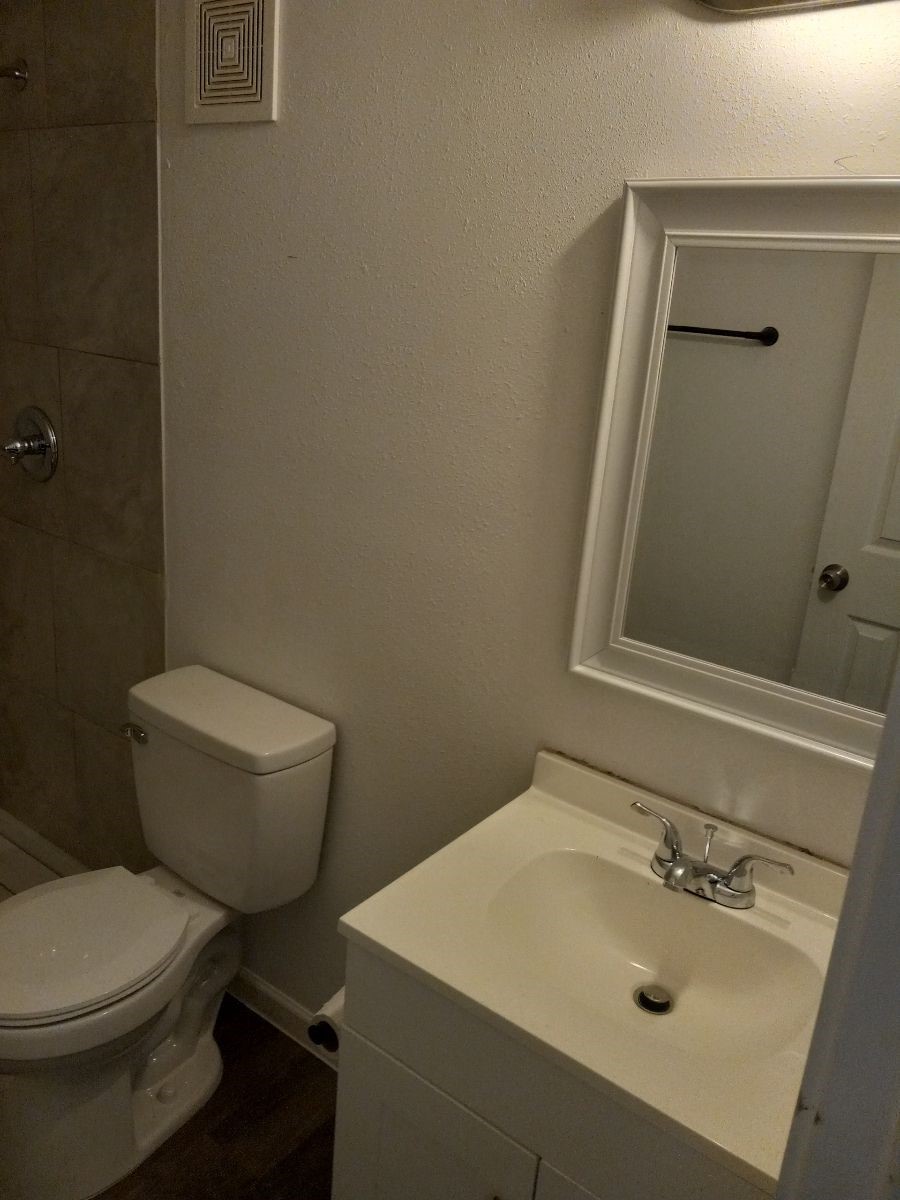 2681 Gessner Road, Unit 402 Houston, TX 77080 - Photo 7 of 11 a bathroom with a sink a toilet and mirror