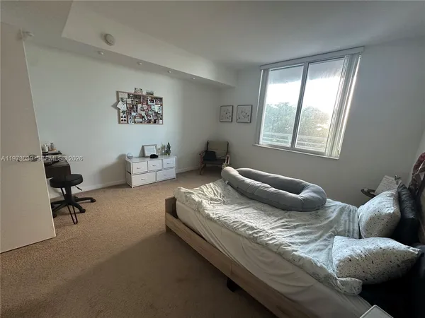 a bedroom with furniture and a window