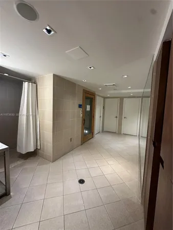 a view of an empty room with wooden cabinet